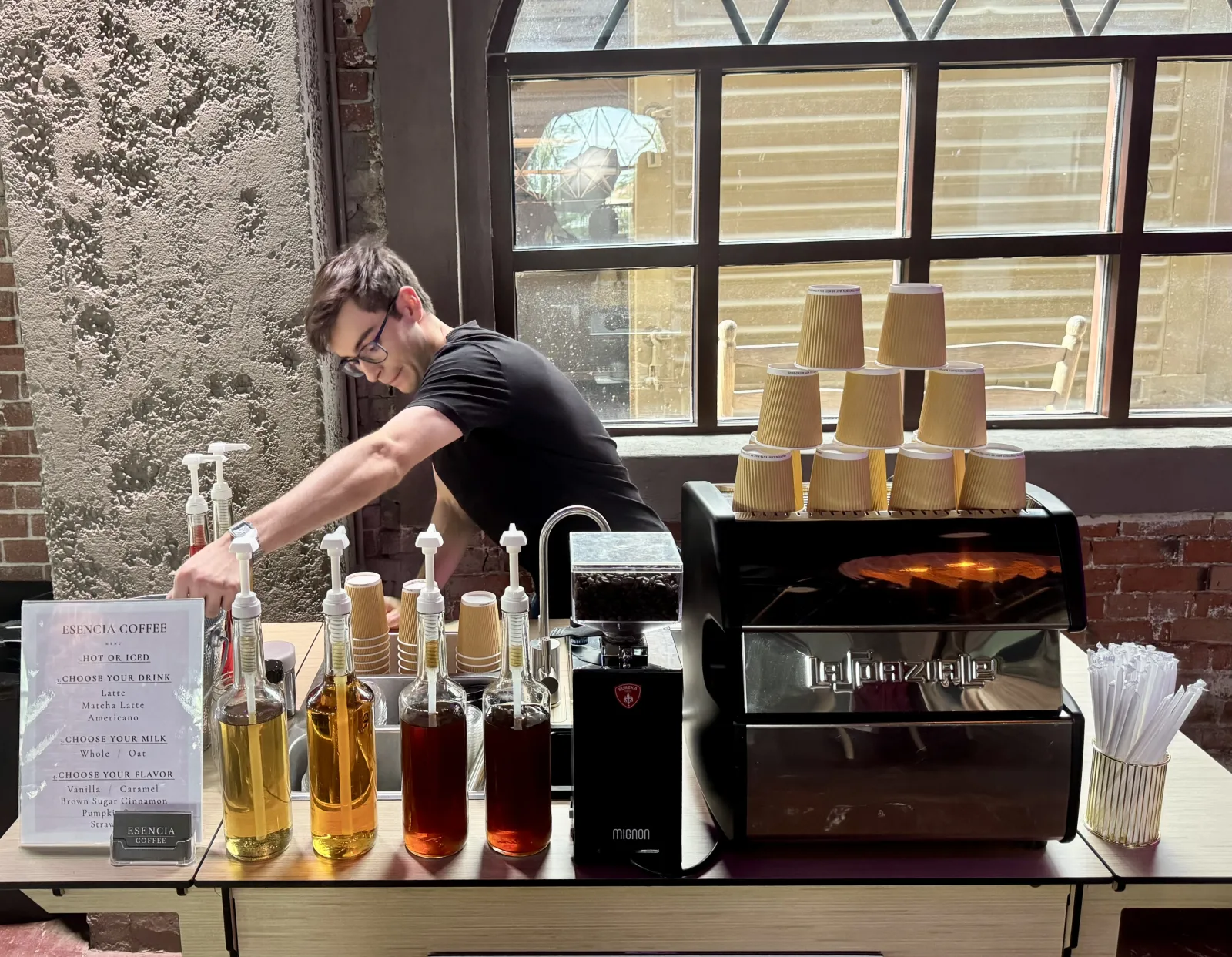 An Esencia Coffee mobile barista setting up the espresso bar before a wedding
