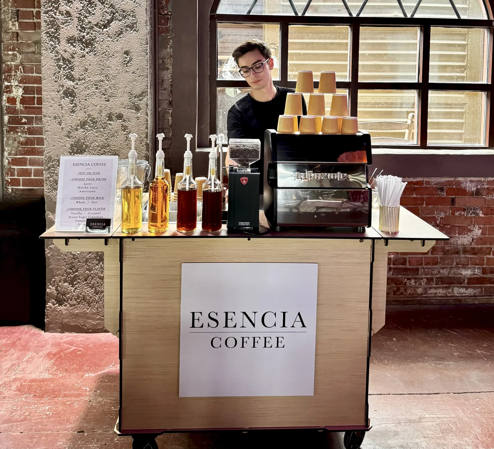 El Paso coffee catering by Esencia Coffee: a barista behind the mobile coffee cart at a wedding