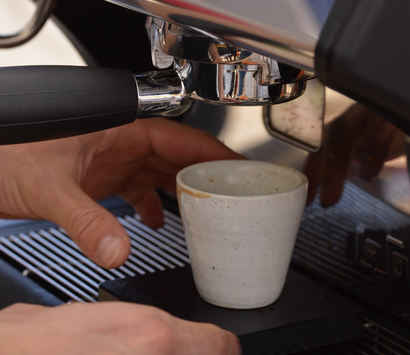 Milk being poured into an iced latte
