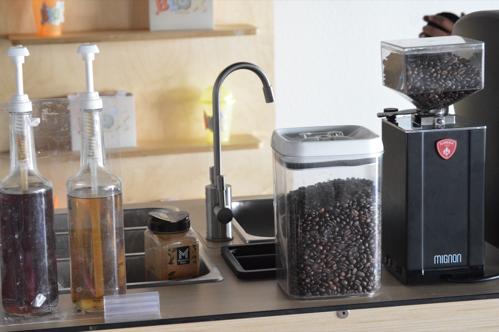 Esencia Coffee espresso bar setup with syrups and grinder at Blox in El Paso, TX